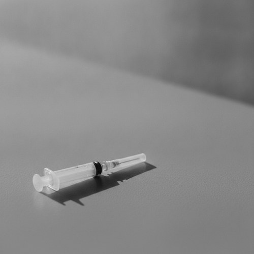 Black and white editorial close study of lips and under-eye area. Filler and biopolymer removal read by Dr. Frank Agullo, MD, FACS.